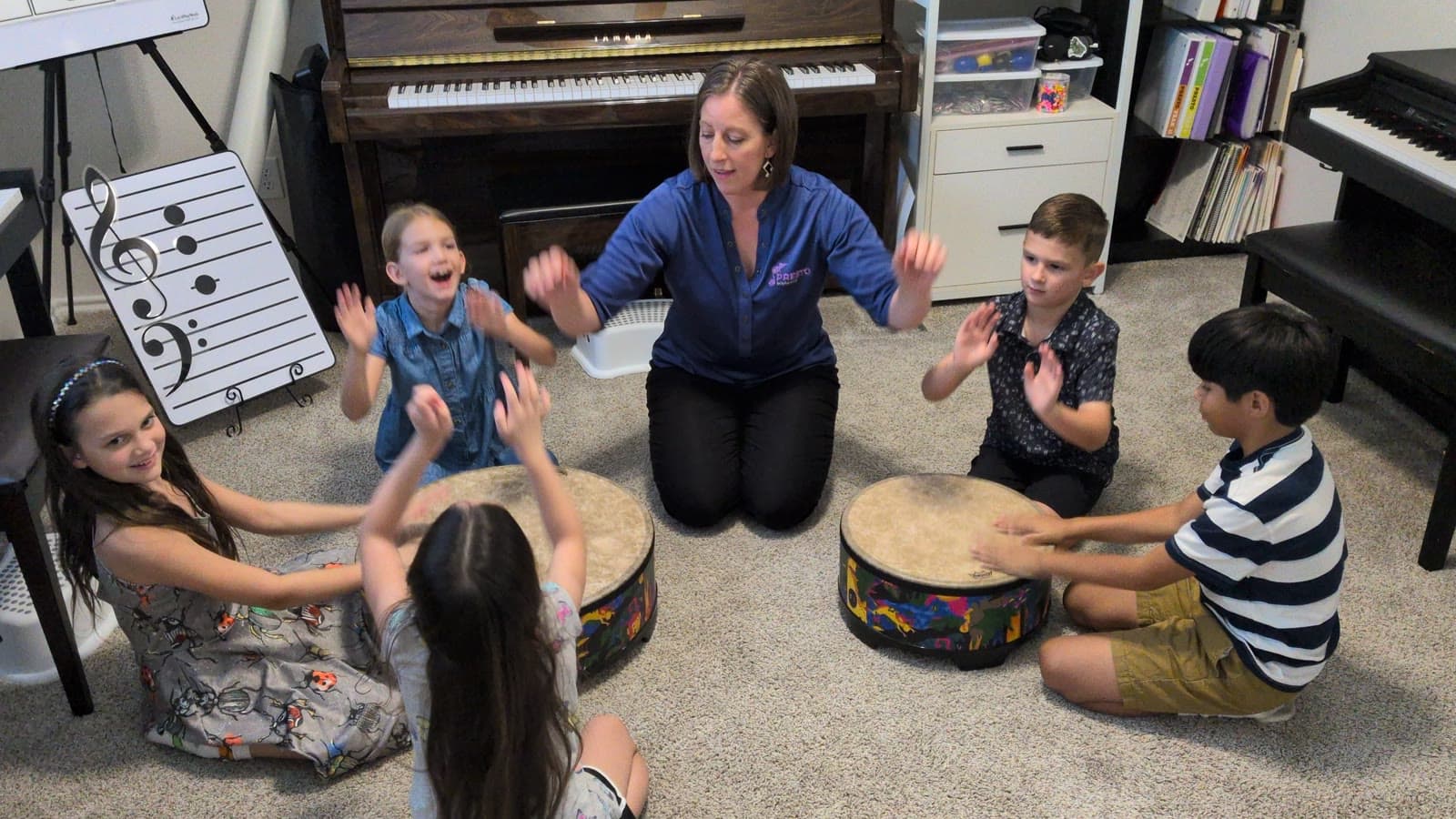 Students practicing rhythm together on drums in Ms. Shannon's studio