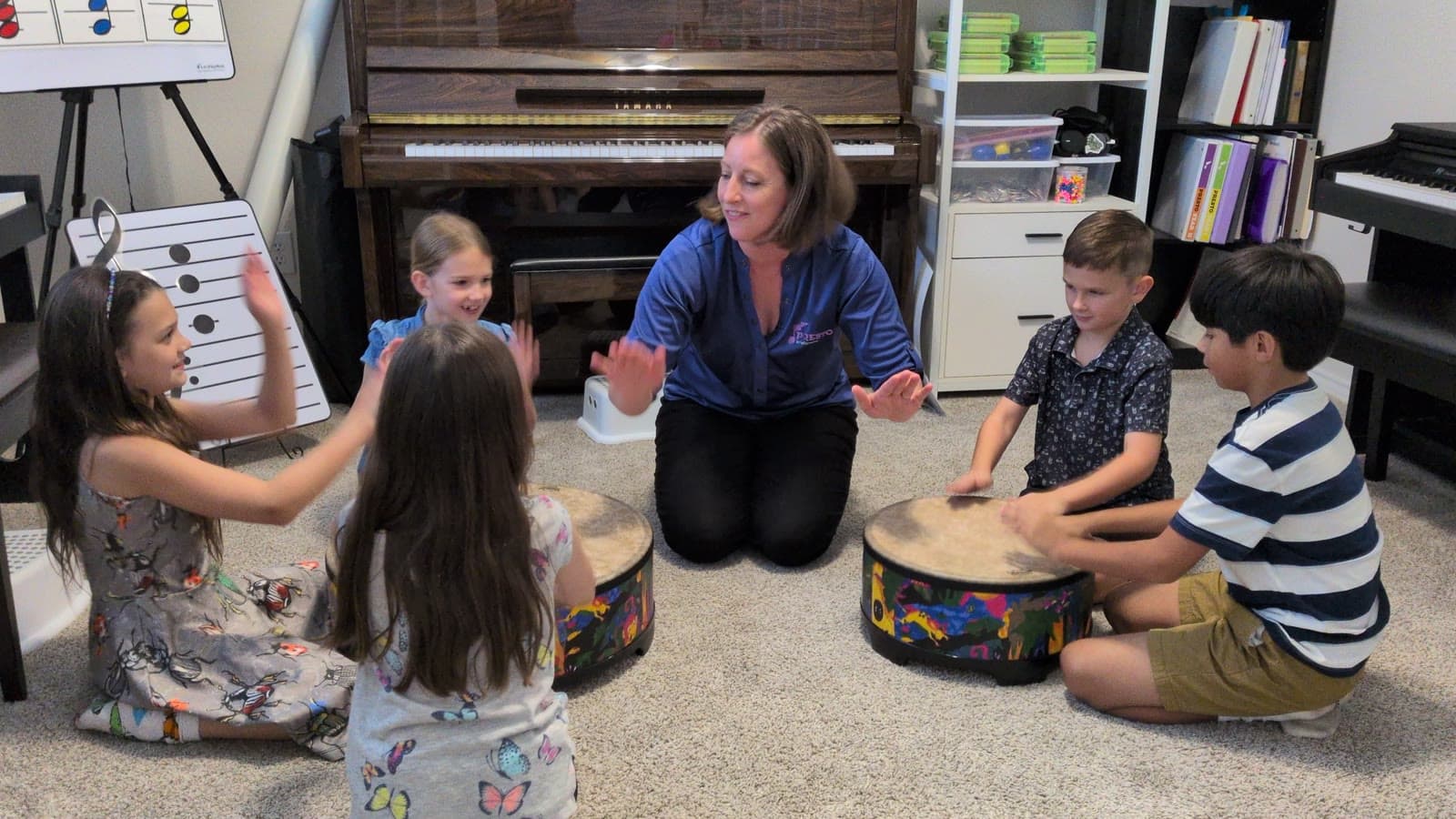 Ms. Shannon and her students playing classroom drums together